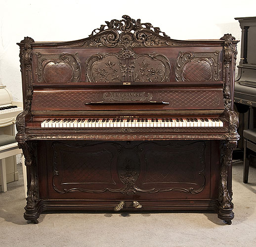 Rococo style, Francke upright piano for sale with an ornately carved, mahogany case and reverse scroll legs. 