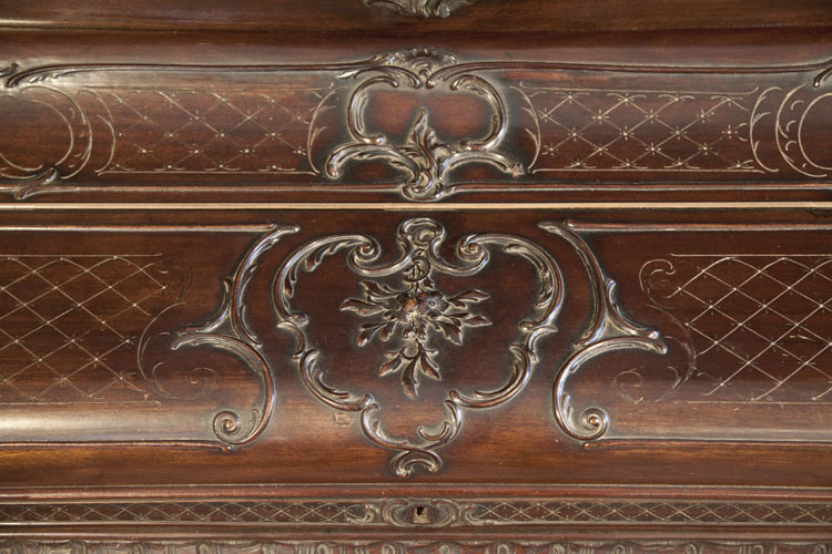 Francke  piano fall featuring carved flowers and scrolling acanthus.