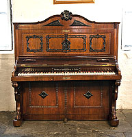 A Holling Spangenberg upright piano for sale with a rosewood case, candlestick holders and claw foot legs
