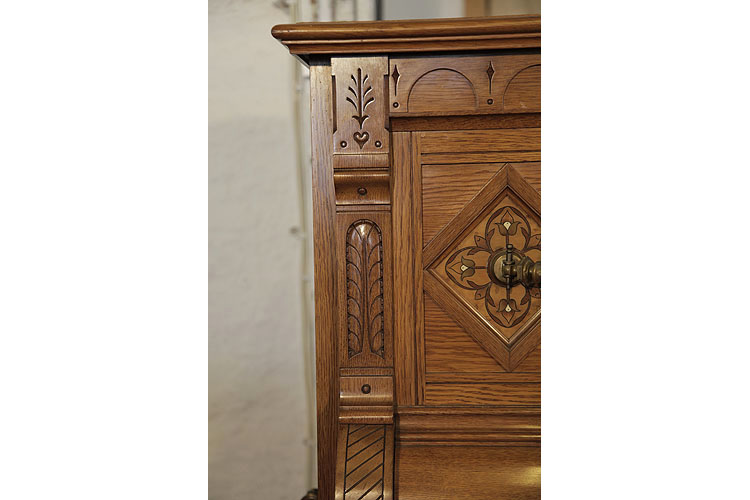 Ibach carved pilaster featuring carved folk art elements including a heart, feather and stylised trees 