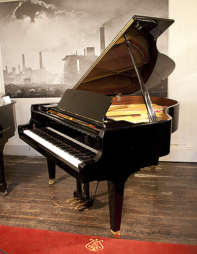 A 2017, Kawai GL-50 grand piano for sale with a black case and square, tapered legs. Keyboard lide features a slow fall mechanism. Piano has an eighty-eight note keyboard and a three-pedal lyre.