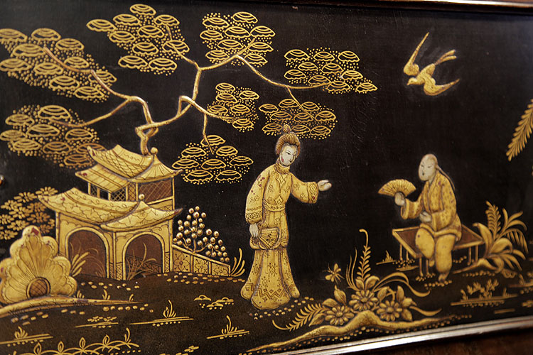 Schiedmayer Chinese scene detail in embossed, black and gold Japanning.  A man sits fanning himself as a bird flies overhead.