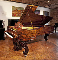 A stunning, 1877, Steinway & Sons Model D concert grand piano with an exquisite wood case and reverse scroll legs.