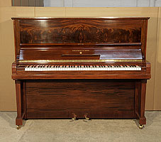 A 1938, Steinway Model V upright piano with a polished, mahogany case. Cabinet features an exquisite, book-matched mahogany front panel