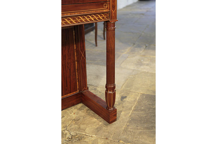 Piano has fluted Doric style piano legs with an urn shaped pedestal