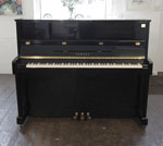 Piano for sale. A Yamaha ET121 upright piano for sale with a black case and brass fittings 