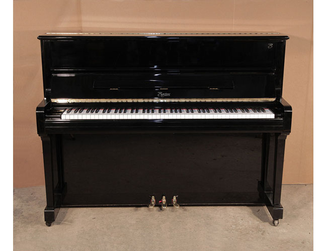 Reconditioned, 2004, Boston UP-118 upright piano for sale with a black case and brass fittings. Piano has an eighty-eight note keyboard and three pedals. 