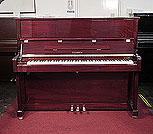 Piano for sale. A brand new, Feurich Model 122 upright piano with a mahogany case and brass fittings.