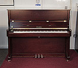 Piano for sale. A brand new, Feurich Model 122 upright piano with a satin, walnut case and brass fittings.