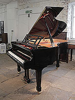 A preowned, Feurich Model 178 Professional grand piano with a black case, openwork music desk and brass fittings