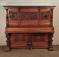  Neoclassical, Hupfer upright piano for sale with an ornately carved, mahogany case and turned, legs. 