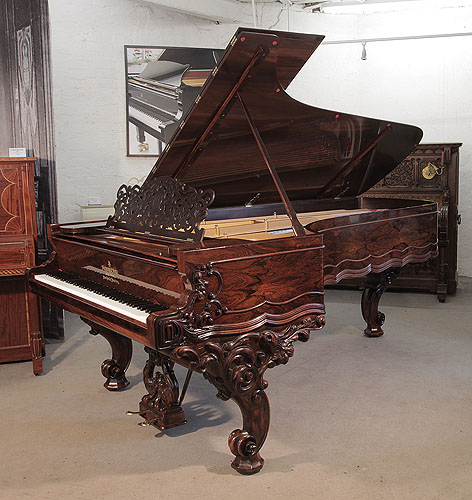 An 1874, Steinway Centennial Concert Grand piano for sale with a rosewood case, filigree music desk and ornately carved, reverse scroll legs