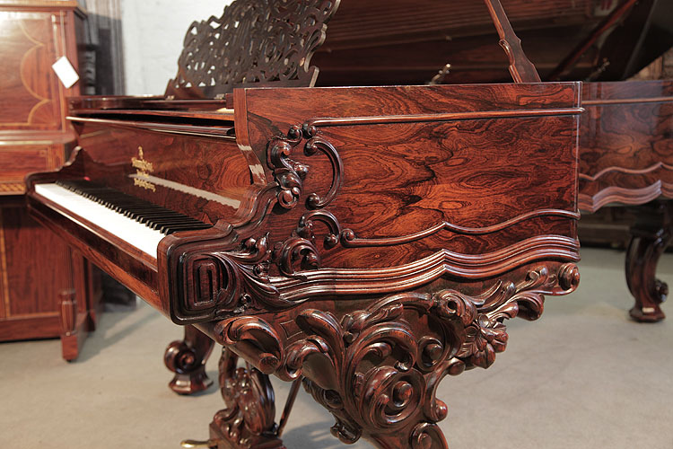 Steinway Centennial grand  piano cheek features a carved, Classical meander and acanthus in high relief.