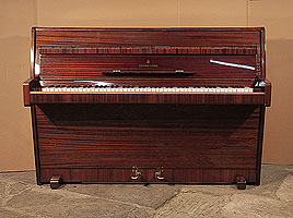 A 1960, Steinway Model F upright piano with a mahogany case and polyester finish