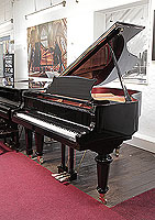 A brand new, Toyama TC-162 grand piano for sale with a black case and spade legs