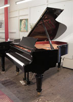 A 2021, Toyama TC-187 grand piano for sale with a black case and turned, faceted legs. Piano features a slow fall mechanism on the keyboard lid. Piano has an eighty-eight note keyboard and a three-pedal lyre..