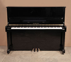 A 1988, Yamaha MC10Bl upright piano with a black case and polyester finish