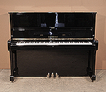 Piano for sale. A 1975, Yamaha U1 upright piano with a black case and polyester finish. Piano has an eighty-eight note keyboard and three pedals.  