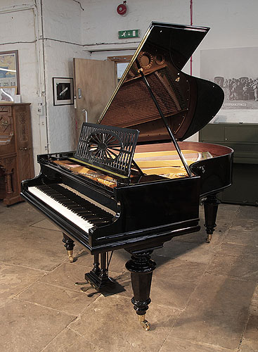A  Bechstein Model A  grand piano with a polished, black case and turned legs