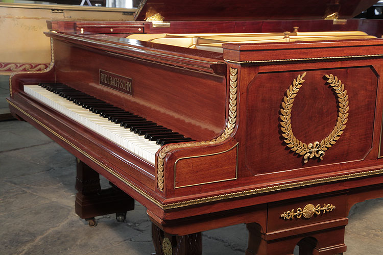 Ibach piano cheek is adorned with ormolu beading accents and a central laurel wreath and bow