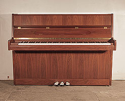 Ottostein SU-108P upright piano with a crown cut, satin, walnut case. Piano has an eighty-eight note keyboard and and three pedals