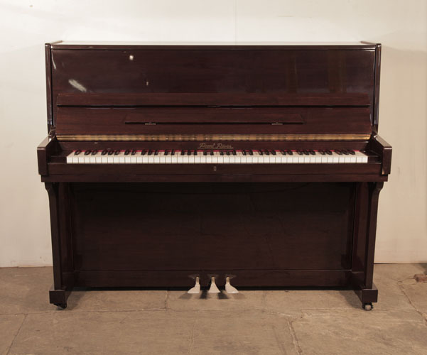  A 2001, Pearl River upright piano with a mahogany case and polyester finish. Piano has an eighty-eight note keyboard and and three pedals