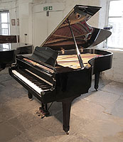 A 1979, Yamaha C7 concert grand piano for sale with a black case and spade legs.