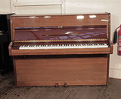 A 1976, Bechstein upright piano with a polished, mahogany case.