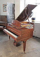 A 1938, Bluthner grand piano for sale with a fiddleback mahogany case and square, tapered legs