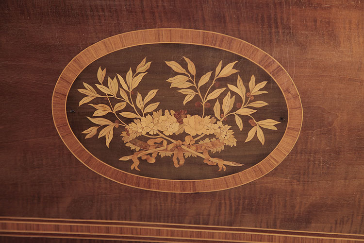 Broadwood inlaid panel featuring a floral head dress and foliage.