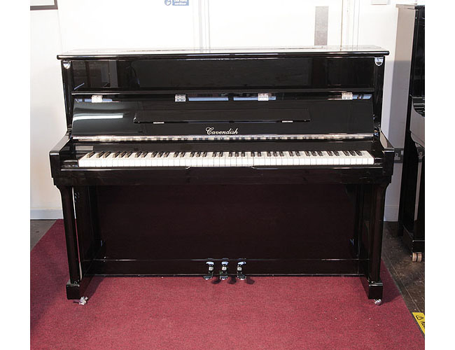  Pre-owned, Cavendish upright piano with a black case and chrome fittings. Piano has an eighty-eight note keyboard and three pedals.  