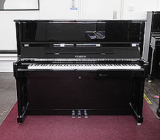 A brand new, Feurich Model 122 upright piano with a black case and chrome fittings