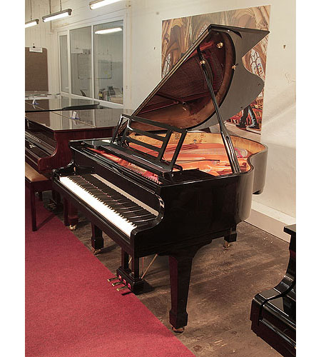 Pre-owned, Feurich Model 161 Professional grand piano with a black case and soft fall mechanism.  Piano has an eighty-eight note keyboard and a three-pedal lyre. 