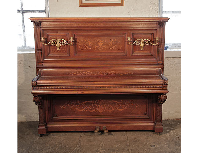 Albert Gast upright piano for sale with a quartered, walnut case and ornate, brass candlesticks. Entire cabinet inlaid in Neoclassical motifs.
