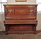 Piano for sale. Albert Gast upright piano for sale with a quartered, walnut case and ornate, brass candlesticks. Entire cabinet inlaid in Neoclassical designs featuring scrolling acanthus, urns and flowers