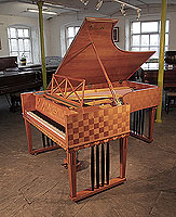 A 1907, Ibach grand piano for sale with a chequered, cherry case, openwork music desk and gate legs with black spindles. Piano one of two designed for Richard Strauss