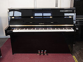 Reconditioned,  2006, Kawai K-15E upright piano with a black case and polyester finish