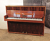 Piano for sale. 
Mid Century Modern style, Monington and Weston upright piano for sale with a mahogany and macassar ebony case. Piano has an eighty-five note keyboard and two pedals. 