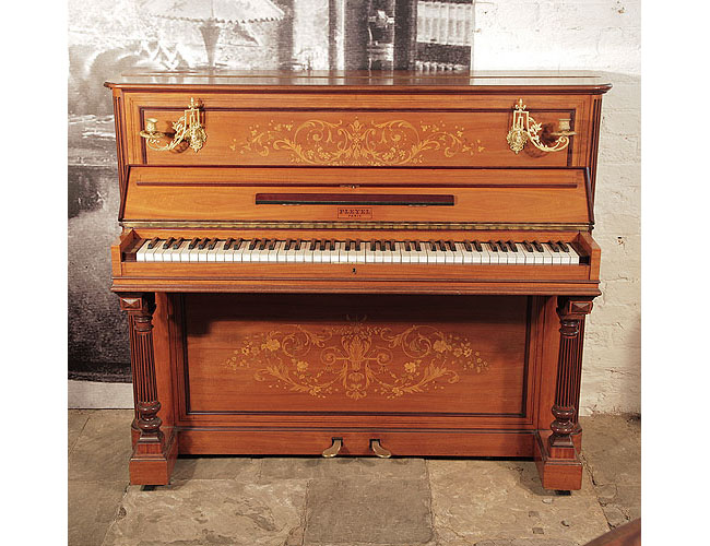 An 1893, Pleyel upright piano with a satinwood case. brass candlesicks and fluted, column legs. Entire cabinet features intricate, Neoclassical style inlay