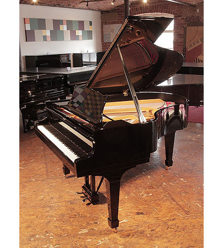 Rebuilt, 1956, Steinway Model M grand piano for sale with a black case and spade legs. Piano has an eighty-eight note keyboard and a two-pedal lyre. 