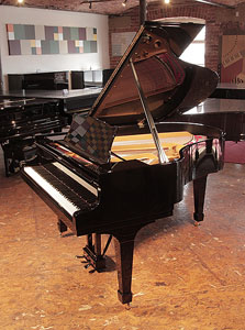 Rebuilt,  1956, Steinway Model M grand piano for sale with a black case and spade legs   