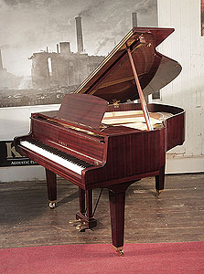 Reconditioned, 1974, Yamaha baby grand piano with a mahogany case and square, tapered legs. Piano has an eighty-eight note keyboard and a two-pedal lyre.