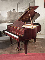 A 1974, Yamaha baby grand piano with a mahogany case and square, tapered legs. Piano has an eighty-eight note keyboard and a two-pedal lyre.