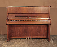 A 2005, Yamaha P121N upright piano with a walnut case and brass fittings