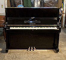 A 1974, Yamaha U1 upright piano with a black case and polyester finish