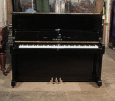 A 1975, Yamaha U1 upright piano with a black case and polyester finish