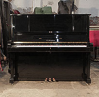 A 1982, Yamaha YUX upright piano for sale with a black case and brass fittings