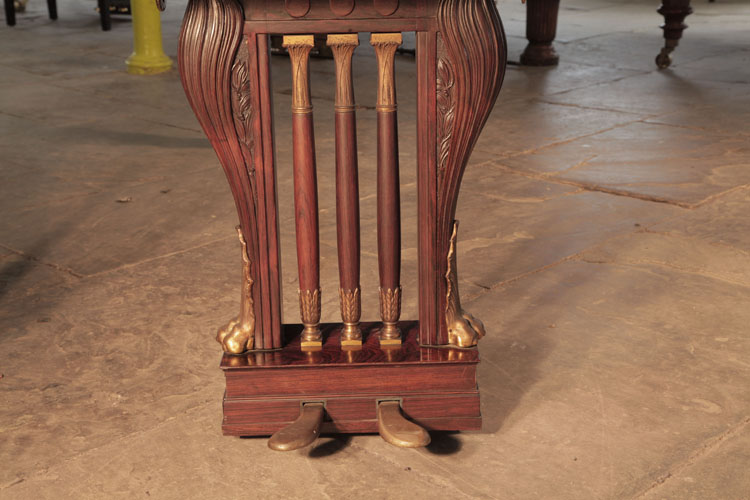Bluthner two-pedal lyre has three central spindles accented with gilted acanthus and palms at either end. Two gilted lions feet frame the cabriole lyre surround