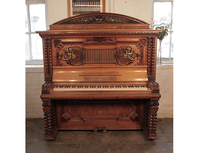 German Late Renaissance style, 1896, Pfaffe upright piano for sale with a walnut case and twelve barley twist legs. Entire cabinet covered with ornate carvings of anthemions, shells, acanthus, strapwork, foliage and flowers in high relief. Piano exhibited in the German Industrial and Art Fair in Berlin 1896.