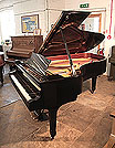 Piano for sale. Reconditioned, 1975, Steinway Model B Steinway Model B grand piano for sale with a black case and spade legs Piano has a three-pedal lyre and an eighty-eight note keyboard.